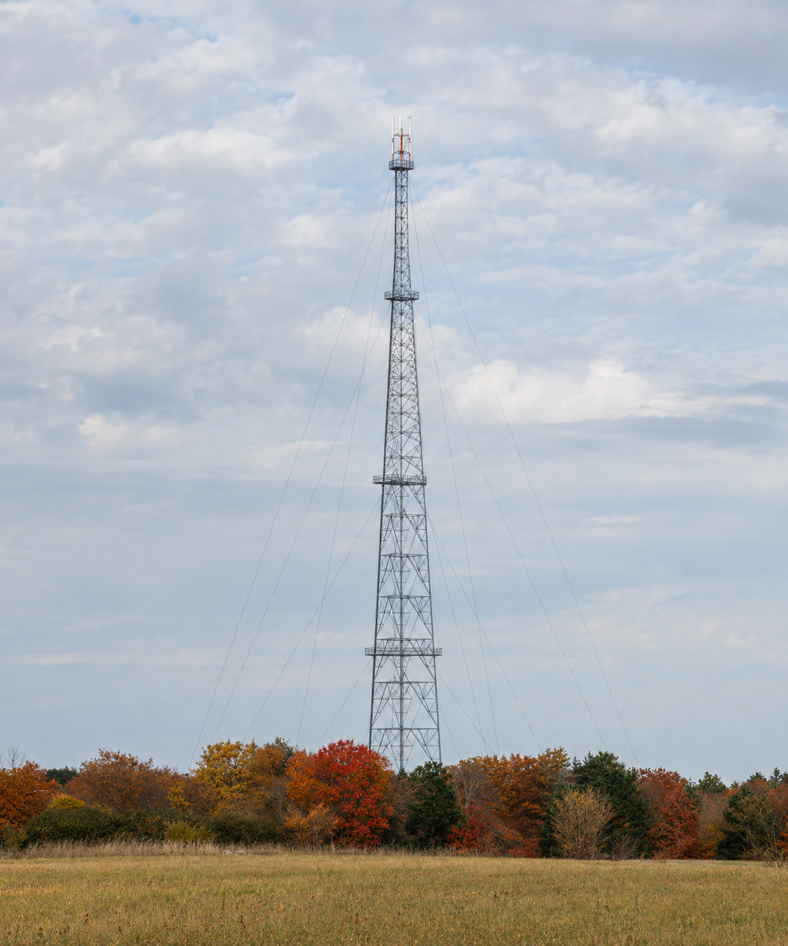 The WRKN radio tower surrounded by autumn foliage
